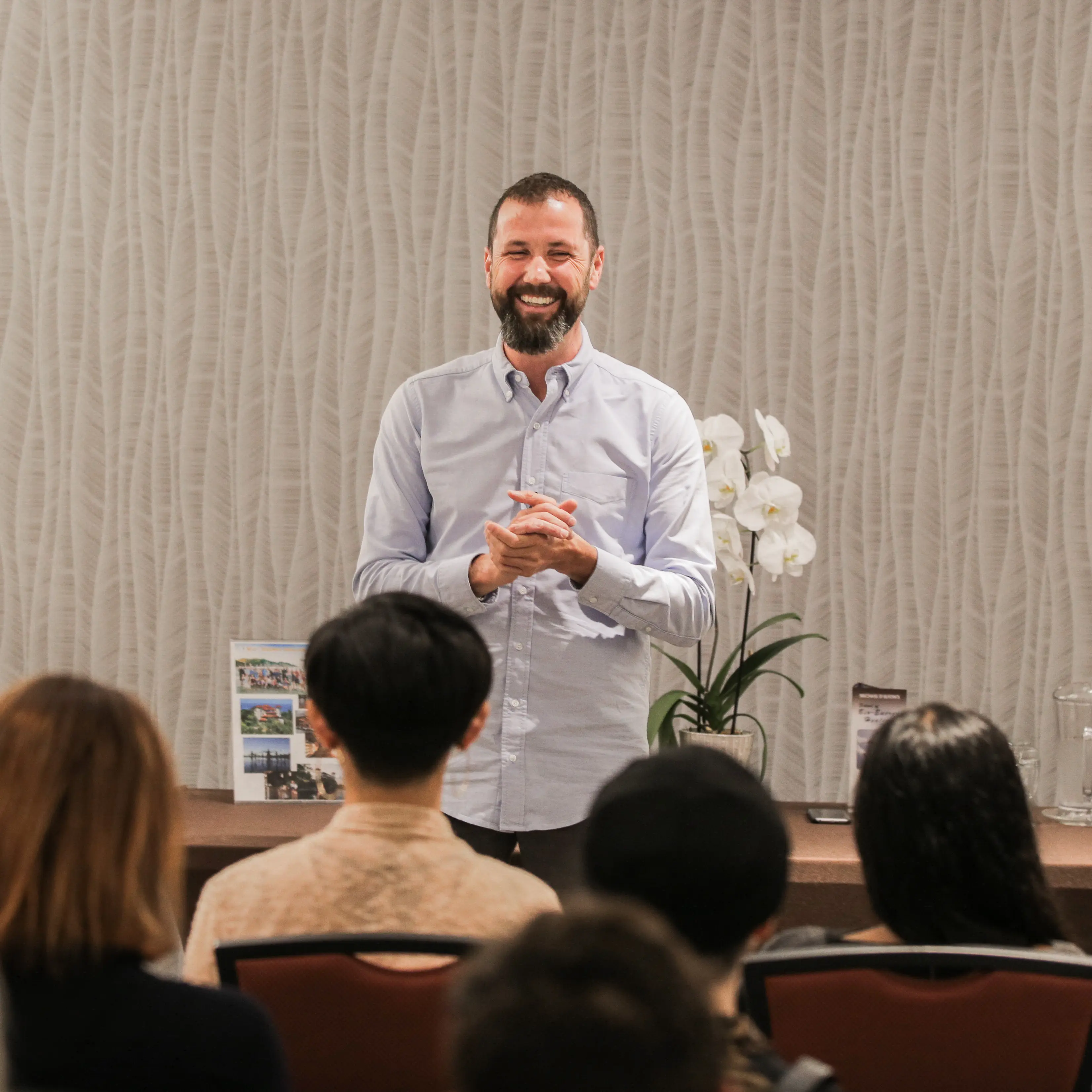 Michael D'Alton giving a presentation in front of a large group of people